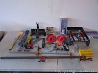 Overview image of assorted tools and hardware spread on table