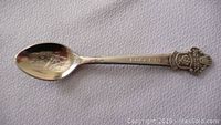 Overall view of the silver-tone souvenir spoon showing the bowl with internal engraving and handle with Lucerne inscription