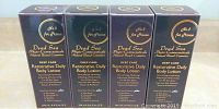 Four boxes of Dead Sea Deep Care Restorative Daily Body Lotion, front view showing product name and branding details.