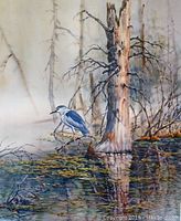 Close-up photo showing a blue heron standing in a watery forested area with detailed reflections and dead trees.