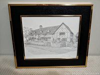 Framed signed print showing Mary Arden's House, black and white with black matting and gold tone frame.
