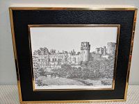 Framed black and white print of Warwick Castle with a gold frame and black matting.
