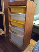 Full view of the wooden storage shelving unit with 6 plastic bins alternating yellow and white colors showing overall condition and dimensions.