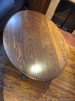 Top view of the solid oak coffee table showing oval shape and wood grain.