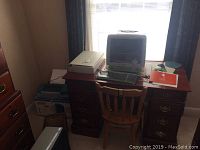 Wide side view of the desk showing the Epson scanner, Epson printer box, and Apple iMac G3 wrapped in plastic on the desk