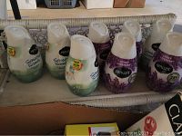 Renuzit Sensual Scent and Lovely Lavender air fresheners in their containers arranged on a tray.