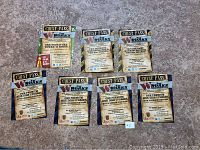 Eight vouchers laid out on floor: two for two gourmet Worksburgers and two 8oz shakes, one for signature tower O Rings, and five for premium side dish upgrades.