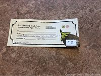 Photo of Patchwork Gardens $25 gift certificate, detailing value, usage date, and branding.