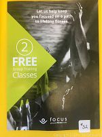 Front of voucher showing 2 free group training classes at Focus Fitness with an image of people exercising.