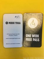 Front and back of a Modo Yoga one-week free pass card
