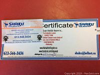 Photo of the Shaku Family Martial Arts gift certificate with contact information, validity and terms, featuring the Shaku logo and branding.