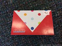 Red Costco gift card envelope with colorful polka dots and Costco Wholesale logo.