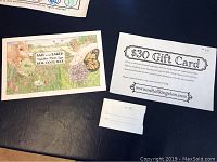 Two Salt Of The Earth $30 paper gift cards with farm-themed artwork and printed redemption details on a dark surface.