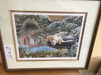 Framed print shown fully, depicting girl with puppies in a nature setting, overall framed size about 22x26 inches.