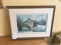 Framed print hanging on wall showing the entire artwork and frame.