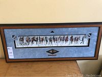 Wide shot of the entire framed print showing mat, frame and mounted arrowheads