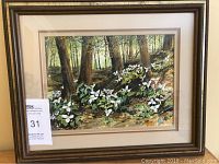 Front view of the framed watercolour artwork showing forest scene with white flowers, signed by S Wilcken.