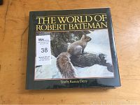 Front cover of 'The World of Robert Bateman' showing title, author text credit to Ramsay Derry, and wildlife illustration of squirrel on tree branch in snow.
