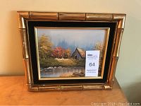 Frontal view of the framed painting showing the entire faux bamboo gilt wood frame and artwork.