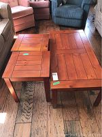 Photo showing the set of three wood tables: one coffee table and two matching end tables. The tables have a warm brown finish with a panel top design.