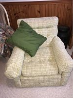 Upholstered Kroehler armchair with light beige textured fabric and green pillow on seat.
