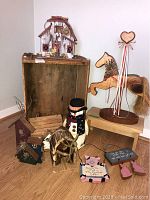Overview of all wooden items including birdhouses, crate, horse statue, stool, signs, and snowman container