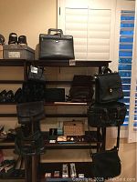Shelf display of Samsonite briefcase top center, multiple handbags on shelves, backpack hanging below
