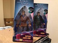 Captain Kirk and Spock dolls in original blue collector's boxes with Star Trek logo and KayBee Toys mark, dolls outfitted in detailed clothing resembling TV characters.
