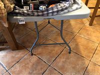 Side view showing metal legs and tiled floor