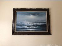 Full view of the framed oil painting depicting crashing ocean waves under a cloudy sky.