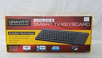 Front view of the Gravitti Wireless Smart TV Keyboard box showing product branding and key features including autolink technology, 52 multimedia keys, touchpad mouse function, nano receiver, and 10m range.