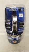 Front view of Wahl rechargeable cordless beard and bare trimmer in sealed packaging showing trimmer and four guide comb attachments, brand and professional use claims visible.