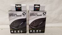 Two Bytech Universal Wireless Optical Mice in their original packaging, front view showing product name and image of mouse