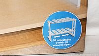 Close-up image of packaging showing adjustable panels feature illustration for the under sink shelf unit.