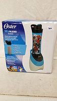 Original boxed packaging of Oster MyBlend Blender, showing front and side views of the box with product image and features.