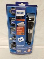 Front view of Philips Series 3000 All-In-One Multigroom trimmer in original sealed packaging showing all attachments