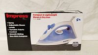 Photo of the boxed Impress Compact & Lightweight Steam & Dry Iron showing branding, features, and model number IM-822