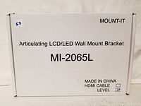 Photo of the Mount-It MI-2065L articulating LCD/LED wall mount bracket box showing the model number and package contents including HDMI cable and level.