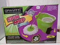 Box of Gravitti Spin Mop Ultra showing brand, product name, and mop system with 360 rotating action and ultra-absorbent microfiber.