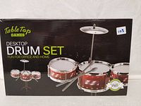 Image of boxed Tabletop Games Desktop Drum Set showing the front of the packaging with the drum set pictured on it.