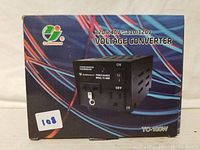 Box packaging of Goldsource voltage converter TC-100W showing front with power sockets and model info