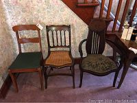 Three vintage chairs and one side table against floral wallpaper and carpeted floor, showing overall look of the lot.