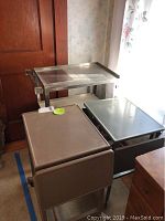 Photo of three metal carts stacked together showing their condition and size.