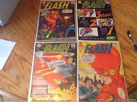 Four Silver Age Flash comics arranged in a grid, showing their front covers including number 170, 173, 175, and 177 with colorful cover art featuring The Flash in action.