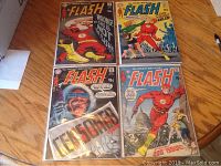 Four Flash comic books laid out on a table showing covers of issues 191, 192, 193, and 200 with vibrant comic art.
