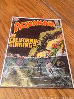 Full front cover of Aquaman comic book, issue 53, featuring cover art about California sinking.
