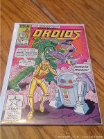 Front cover of the comic showing the full colorful illustration featuring droids and Marvel branding.