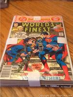 Photo showing the front of the comic books pile highlighting World’s Finest with Superman and Batman on front cover