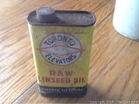Front side of the yellow metal raw linseed oil can showing Toronto Elevators logo and English text