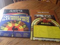 Photo of the 25 Famous Country & Western Hits record cover with other records behind it